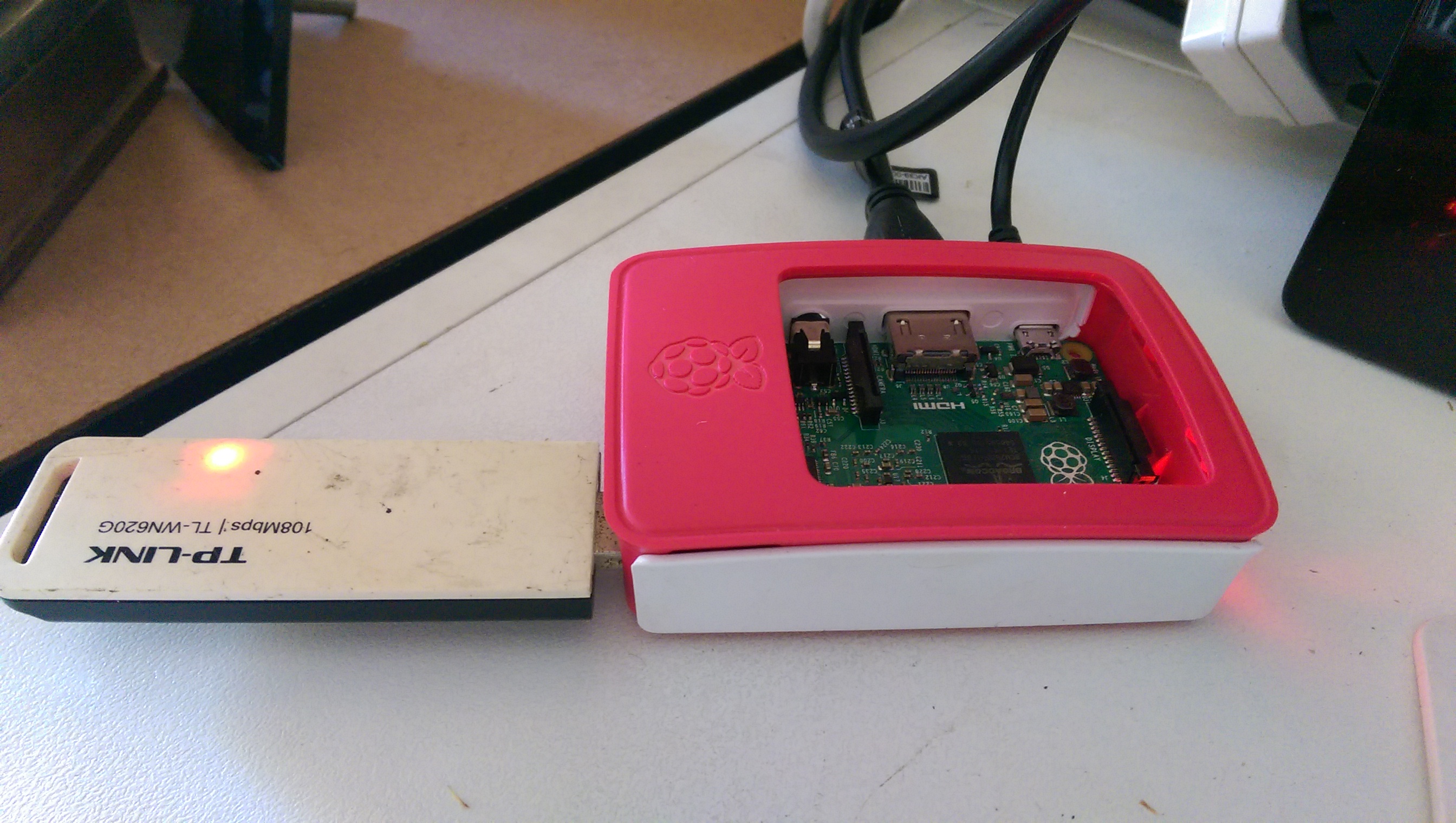 Raspberry Pi Model B, in the offical case and an USB Wireless LAN stick